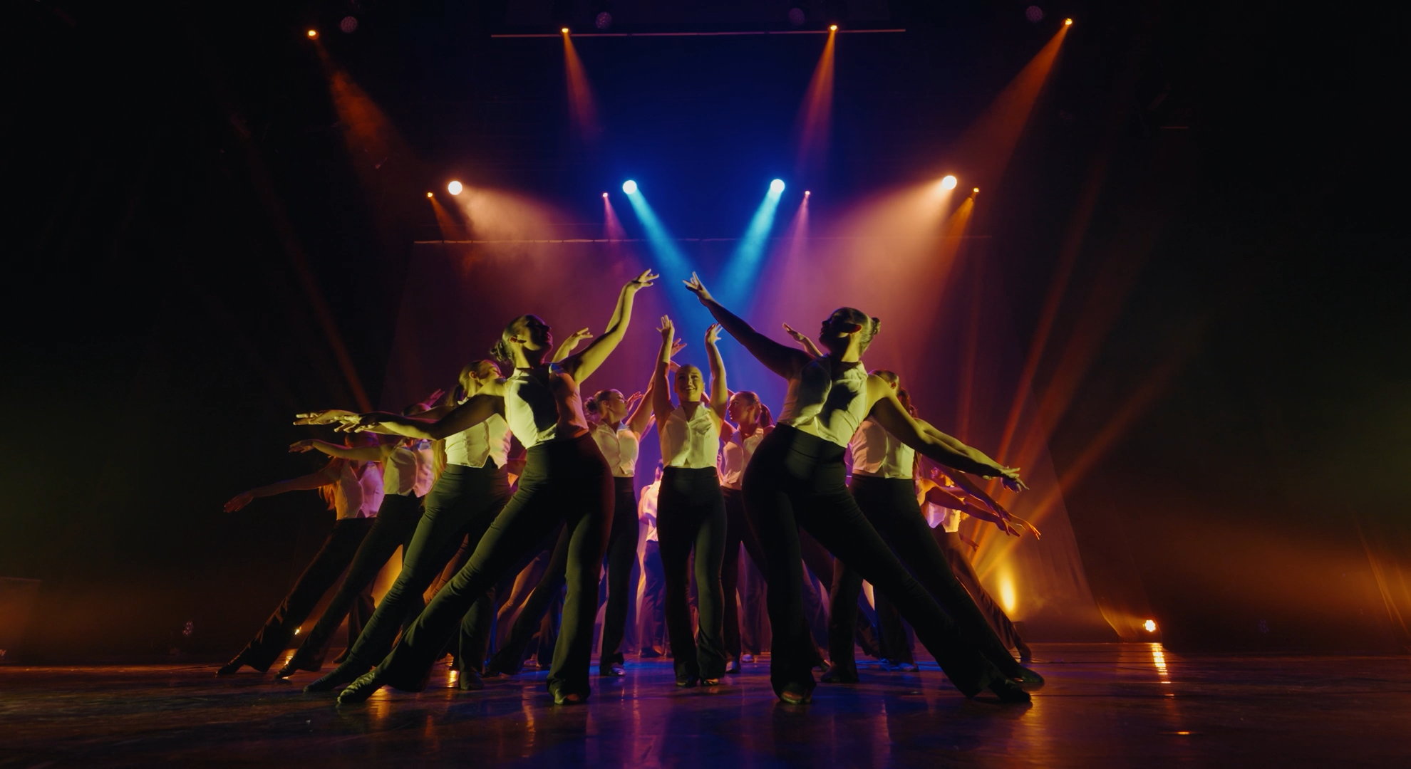 Dance school showcase performance under theatre lights